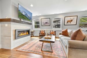 a living room with a couch and a fireplace at Walk to Skiing, Stunning Top Floor Condo at Park City Base, Professionally Decorated Luxury 2BR in Park City