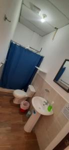 a bathroom with a toilet and a sink at Apartamentos Mundo Maya in Flores
