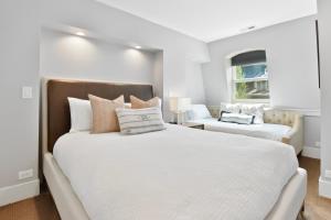 a white bedroom with a large bed and a couch at Walk to Skiing, Stunning Top Floor Condo at Park City Base, Professionally Decorated Luxury 2BR in Park City