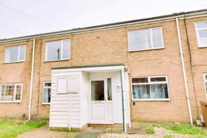 a large brick building with a white garage at Bottesford Apartments in Brumby