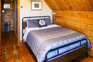 a bedroom with a bed in a wooden room at Sunny Acres Cabin in Moab