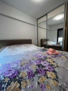 a bedroom with a bed with a flower blanket at Apartman Paradise Fojnica in Fojnica