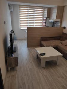 a living room with a couch and a coffee table at Двушка для гостей in Baku
