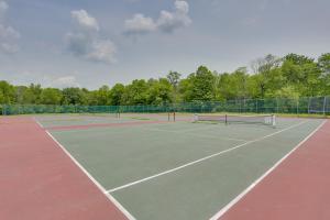 a tennis court with a net on top of it at Pet-Friendly Poconos Abode - Pool, Pond and Fire Pit in Pleasant Mount