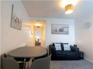 Upper Ashby Apartments في Brumby: غرفة معيشة مع طاولة وأريكة