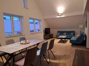 a living room with a table and chairs and a couch at Ferienwohnung Natalie in Kaisersesch