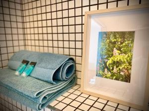 a bathroom with a towel and a picture on the wall at Apartamenty Młyńska 3A in Gliwice +45 photos