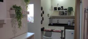 a kitchen with a sink and a counter top at Hospedagem Quarto Chic centro Cunha in Cunha