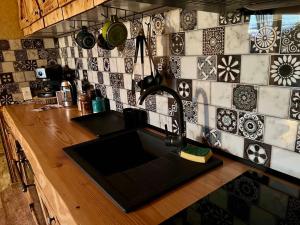 a kitchen with a sink and a counter with tiles at Pod Aniołem in Świerzawa