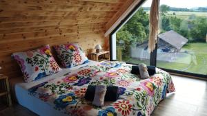 a bedroom with a bed with a large window at Pod Aniołem in Świerzawa