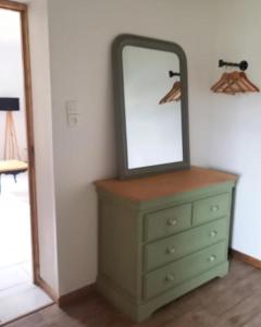 a dresser with a mirror on top of it at L'écrin de Louise in Barry-dʼIslemade