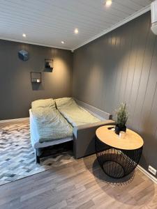 a bedroom with a bed and a table in it at Et koselig hus i vakre Lofoten in Stamsund