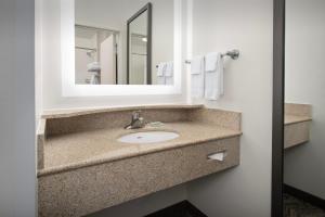 a bathroom with a sink and a mirror at SpringHill Suites by Marriott Portland Vancouver in Vancouver