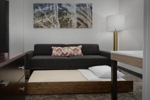 a living room with a couch and a table at SpringHill Suites by Marriott Portland Vancouver in Vancouver