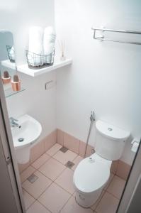 a bathroom with a toilet and a sink at Coolspace @ SMDC Wind Residence Budget, WIFI, NETFLIX in Tagaytay +6 photos
