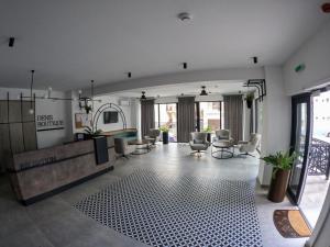 a large room with a lobby with chairs and a mirror at Denis Boutique in Eforie Nord