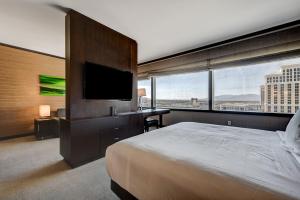 a bedroom with a large bed and a flat screen tv at Vdara Hotel & Spa in Las Vegas