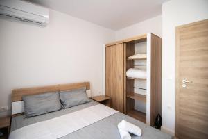 a small bedroom with a bed and a closet at Azur Deluxe Flats in St. St. Constantine and Helena