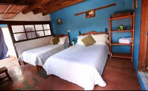 Ліжко або ліжка в номері HOTEL RINCÓN MAGICO REAL DE CATORCE
