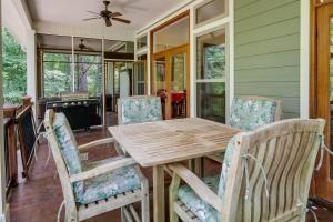 a dining room with a wooden table and chairs at Waterfront Loranger Cottage Hot Tub, Deck and Grill in Loranger