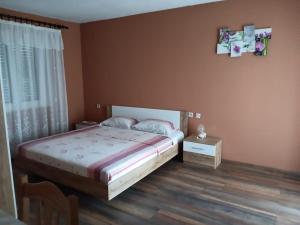a bedroom with a large bed and a window at Apartments Jadro in Kali