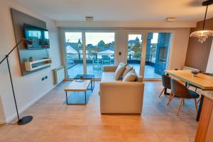 a living room with a couch and a table at Patagonia Deluxe View in San Carlos de Bariloche