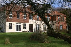 a large brick house with a bench in front of it at Moorlands in Parracombe