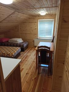 a room with a desk and a table in a cabin at Kwatera u Stasia in Szczebrzeszyn