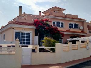 a large pink house with a fence at Casa Atlantica Golf & Sea view in Caleta De Fuste