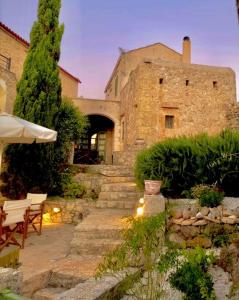 a stone building with a table and chairs in a yard at Villa Melodia in Vamos