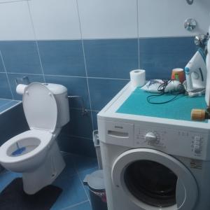a bathroom with a washing machine and a toilet at Apartment Andjela in Belgrade +9 photos