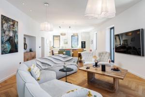 a living room with a white couch and a table at Villa B with Old town & sea view in Dubrovnik