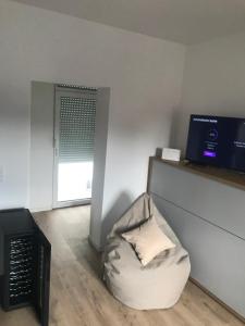 a living room with a bean bag chair and a television at Erholungszeit - Mein kleines Paradies in Bad Kreuznach