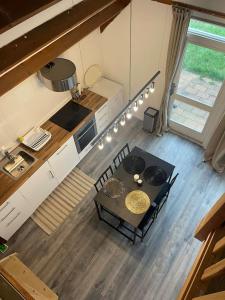 an overhead view of a kitchen with a table and chairs at Leuke bungalow in Noord-Holland in Opmeer +5 photos