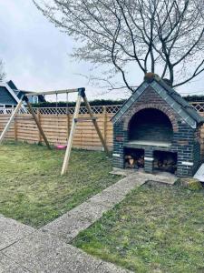 a dog house with four dogs inside of it at Leuke bungalow in Noord-Holland in Opmeer