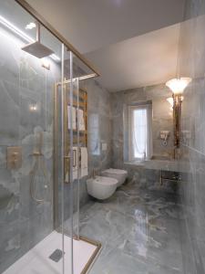 a bathroom with a shower and a toilet and a sink at Casa Balzola - Suite Incanto in Alassio