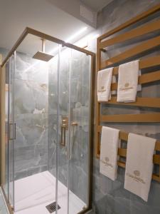 a shower in a bathroom with white towels at Casa Balzola - Suite Incanto in Alassio