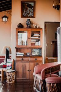 a wooden cabinet in a living room with a couch at Su Casa in Ensenada