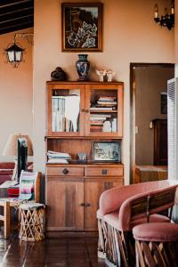a wooden cabinet in a living room with a couch at Su Casa in Ensenada +18 photos