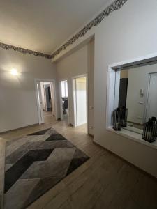 an empty room with a large mirror and wooden floors at Room Verona Mamma Bianca in Verona +2 photos
