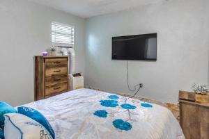 a bedroom with a bed and a flat screen tv at Boynton Beach Vacation Rental about 4 Mi to Beach! in Boynton Beach