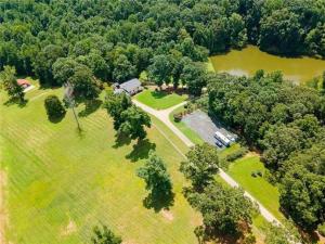 an aerial view of a park with a house and trees at Southern Home and fishing lake. in Gainesville