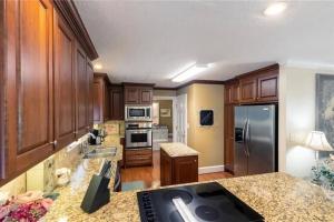 a kitchen with wooden cabinets and a granite counter top at Southern Home and fishing lake. in Gainesville