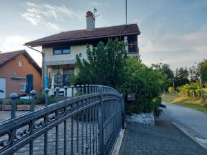 a metal fence in front of a house at Apartman Nada in Ozalj