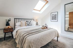 a bedroom with a large bed and a skylight at Principality View Apartment Three, by Solace Stays in Cardiff