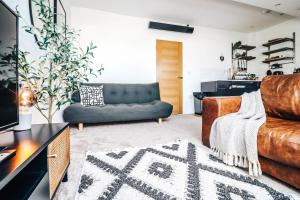 a living room with a couch and a table at Principality View Apartment Three, by Solace Stays in Cardiff