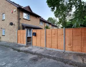 an orange fence in front of a house at Superb One bedroom house in Thamesmead