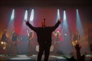 a man standing in front of a group of people on a stage at Carnaby Holiday Caravan, West Sands, Selsey in Selsey