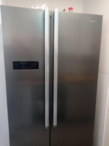 a stainless steel refrigerator in a kitchen at El Picacho de Ítrabo Ático in Ítrabo