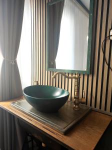 a bathroom with a bowl sink and a mirror at Haus an der Mosel in Bruttig-Fankel +52 photos